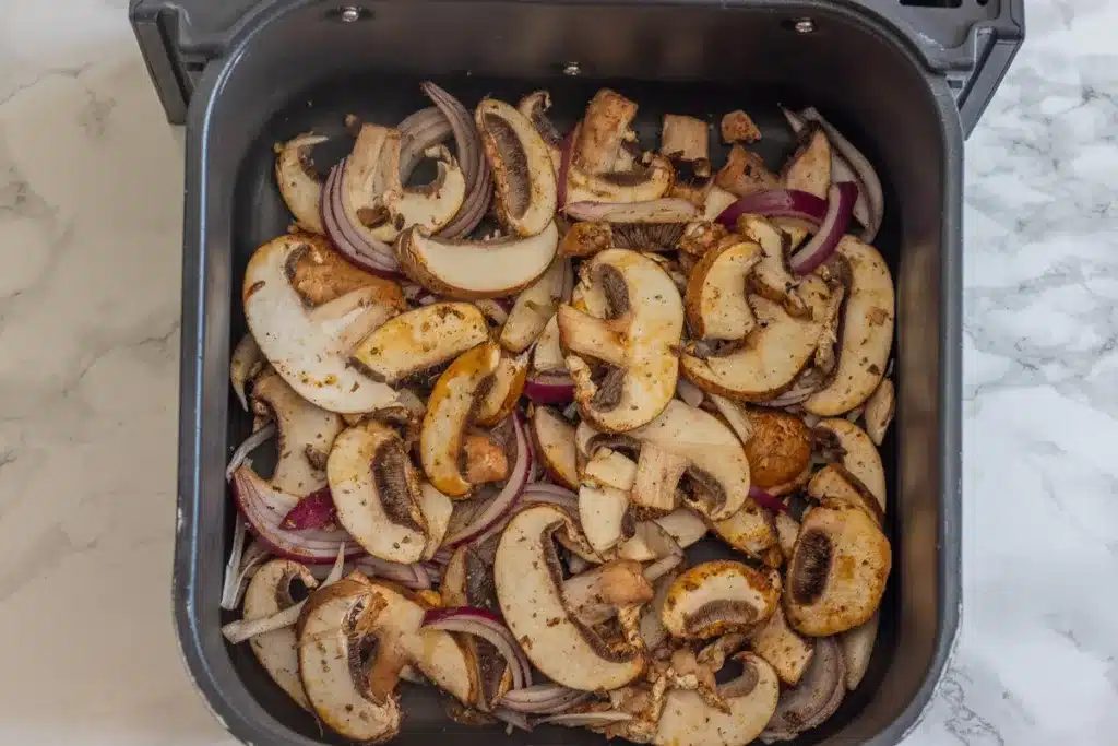 sliced vegetables are placed in air fryer basket
