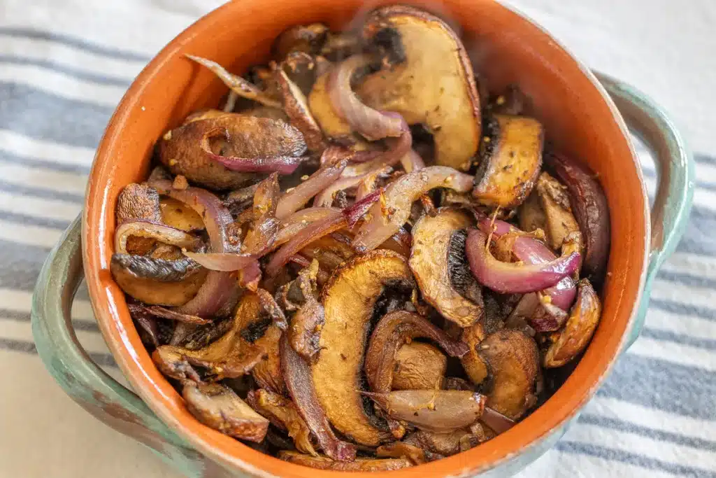 mushrooms and red onions cooked in an air fryer