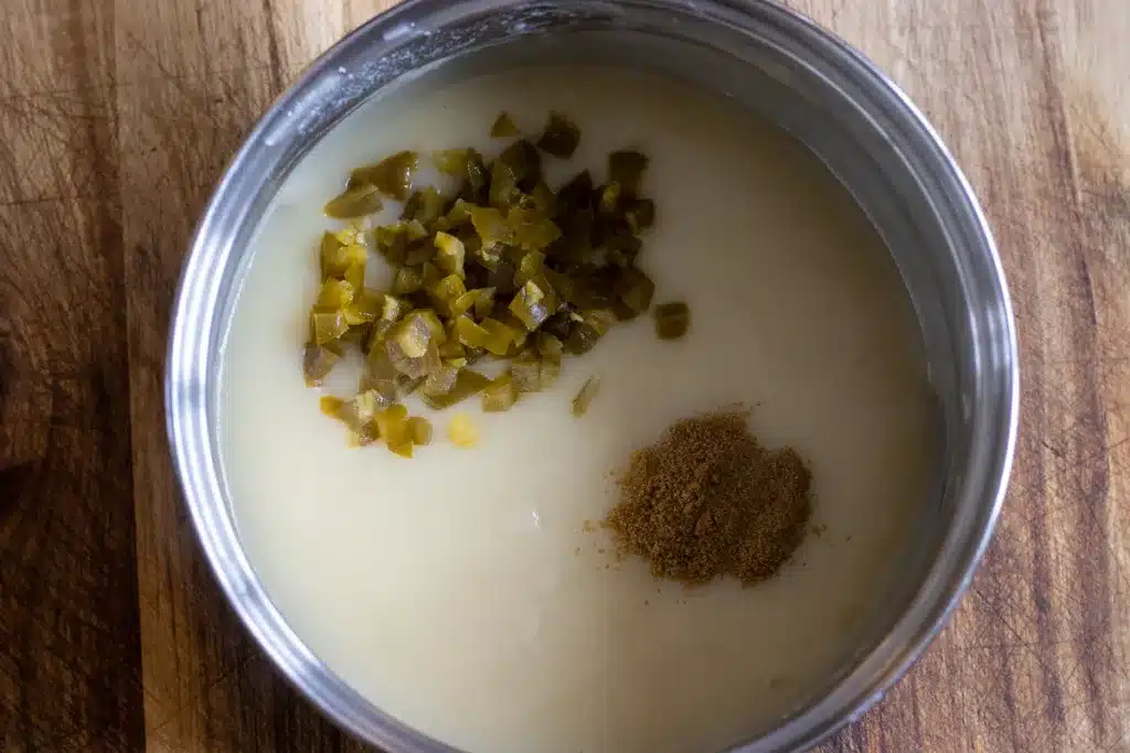 jalapeños and spices are added to white sauce