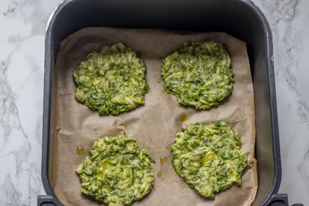 4 pieces of mucver are placed in air fryer basket lined with paper