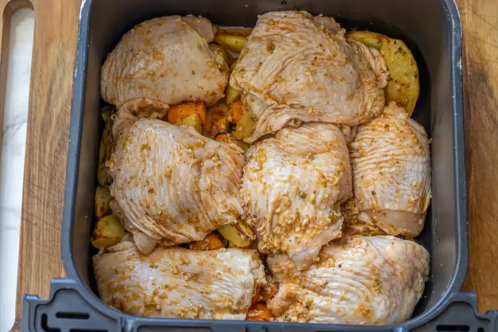 chicken pieces are added to partly cooked veggies